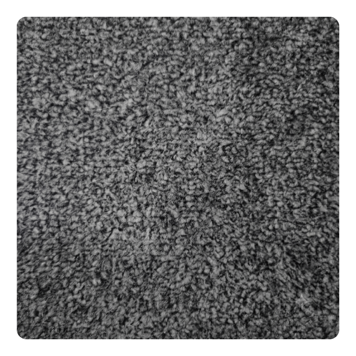 Close-up texture of gray carpet pile showing soft, dense fibers with neutral color and plush surface finish